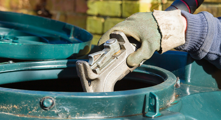 gloved hand filling up a domestic oil tank